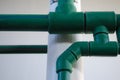 Green plastic pipes close up. Part of the wall water pipe Royalty Free Stock Photo