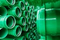 Green plastic pipes lie in rows Royalty Free Stock Photo