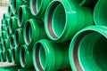 Green plastic pipes lie in rows Royalty Free Stock Photo