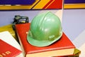 Green plastic safety helmet for the worker. Protective helmet to