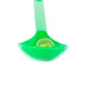 green plastic spoon.Capsules fish oil isolate on white backgrou