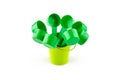 Green plastic spoons in small bucket. Isolated on white background Royalty Free Stock Photo