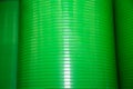 Green plastic tanks stacked in a vertical stack. Construction, repair, household