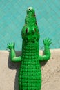 Green plastic toy crocodile on a swimming pool side Royalty Free Stock Photo