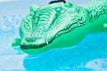 Green plastic toy crocodile in the water Royalty Free Stock Photo