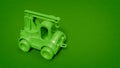 Green plastic toy truck on green background