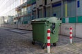 Green plastic waste garbage container bin on sidewalk. Royalty Free Stock Photo