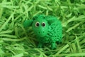 Green plasticine lamb enclosed with green paper raffia strips. Closeup Royalty Free Stock Photo