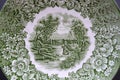 Green plate of an old english porcelain with a rural scene. Retro tableware Royalty Free Stock Photo