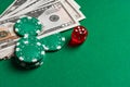 Green Poker Chips, Red Dice, and US Dollar Bills on a Green Felt Tabletop Royalty Free Stock Photo