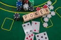 on a green poker table are cards, chips and the inscription poker on wooden cubes Royalty Free Stock Photo