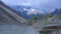 Green poplar trees with small house on hunza river bank