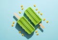 Green popsicles with scattered corn kernels isolated on white background Royalty Free Stock Photo