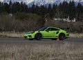 Green Porsche car racing on a runway in Washington