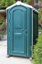 Green portable toilet or Porta Potty on a construction site