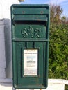 A green post box from the reign of King George VI in Scotland