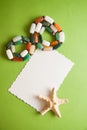 Green postcard with beads and shells Royalty Free Stock Photo