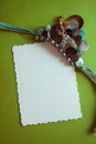 Green postcard with beads and shells Royalty Free Stock Photo