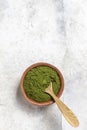 Green powder chlorella, spirulina on gray concrete background. Concept dieting, detox, healthy superfood, which contains protein