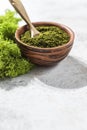 Green powder chlorella, spirulina on gray concrete background. Concept dieting, detox, healthy superfood, which contains protein Royalty Free Stock Photo