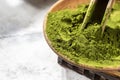 Green powder chlorella, spirulina on gray concrete background. Concept dieting, detox, healthy superfood, which contains protein Royalty Free Stock Photo