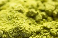 Green powder Japanese matcha tea close-up. The powder contains an admixture of white granules of coconut milk. Matcha latte in dry Royalty Free Stock Photo