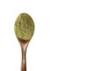 Green powder in a wooden spoon on an insulated white background. Dried organic wheatgrass. Copy space. Diet, detox Royalty Free Stock Photo