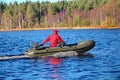 Green, powerboat, inflatable rubber boat with motor on wood lake