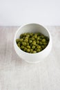 Green preserved peas in the china plate