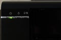 The green printer light is on on the black printer body, close-up Royalty Free Stock Photo