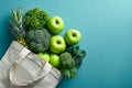 Green produce spilling from a beige tote bag Royalty Free Stock Photo