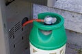 Green propane gas connected to a grill