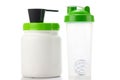 Green protein shaker, scoop and jar on white
