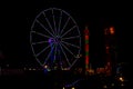 Green and Purple July 4th Ferris Wheel in Carnival at Night Royalty Free Stock Photo