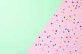 Green and purple pastel color abstract geometric festive background with colorful stars confetti. Royalty Free Stock Photo