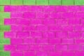 Green and purple pink paint on brick blocks urban color vibrant design wall texture background architecture Royalty Free Stock Photo