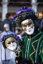 The green and purple smiling mask at the Venice Carnival.