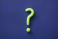 Green question mark on blue background. Abstract 3d model, mock-up of interrogation point. Asking for important information,