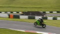 A green racing bike speeding over the brow. Royalty Free Stock Photo