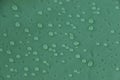 Rain drops on the green rainproof tent sheet. Royalty Free Stock Photo