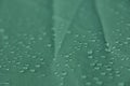Rain drops on the green rainproof tent sheet. Royalty Free Stock Photo