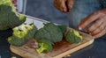 Green, raw and fresh broccoli, cutting knife and board, healthy food