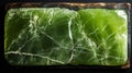 A green rectangular object with cracks