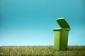 Green recycle bin on green grass Royalty Free Stock Photo