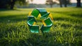 Green recycle symbol made of translucent glass set against lush verdant landscape