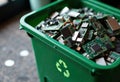 Green recycling bin filled with electronic circuit boards and components Royalty Free Stock Photo