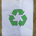 Green recycling icon on a tissue paper, reuse daily waste paper and reduce pollution, creative environmental protection background