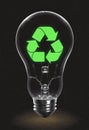 Green recycling symbol inside circle light bulb, glass font Royalty Free Stock Photo