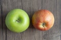 Green and red apple on wooden background