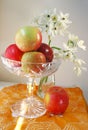 Apples in a crystal bowl and white flowers
